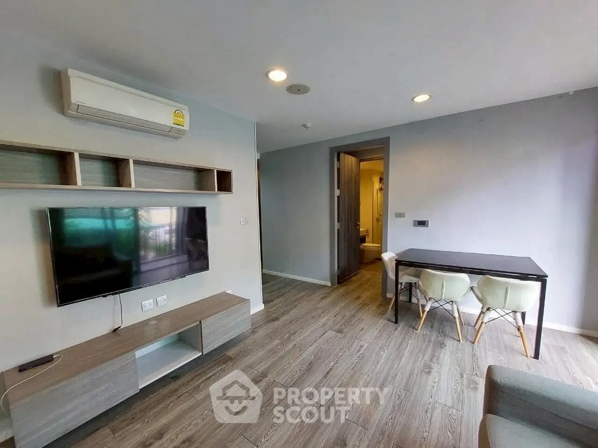 Modern living room with sleek furniture and wooden flooring