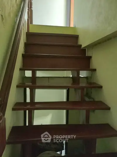 Charming wooden staircase in cozy home interior, perfect for adding character and warmth to your living space.