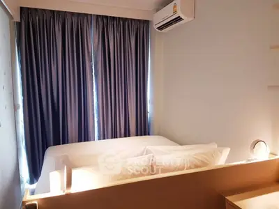 Cozy bedroom with modern air conditioning and elegant curtains, perfect for relaxation.