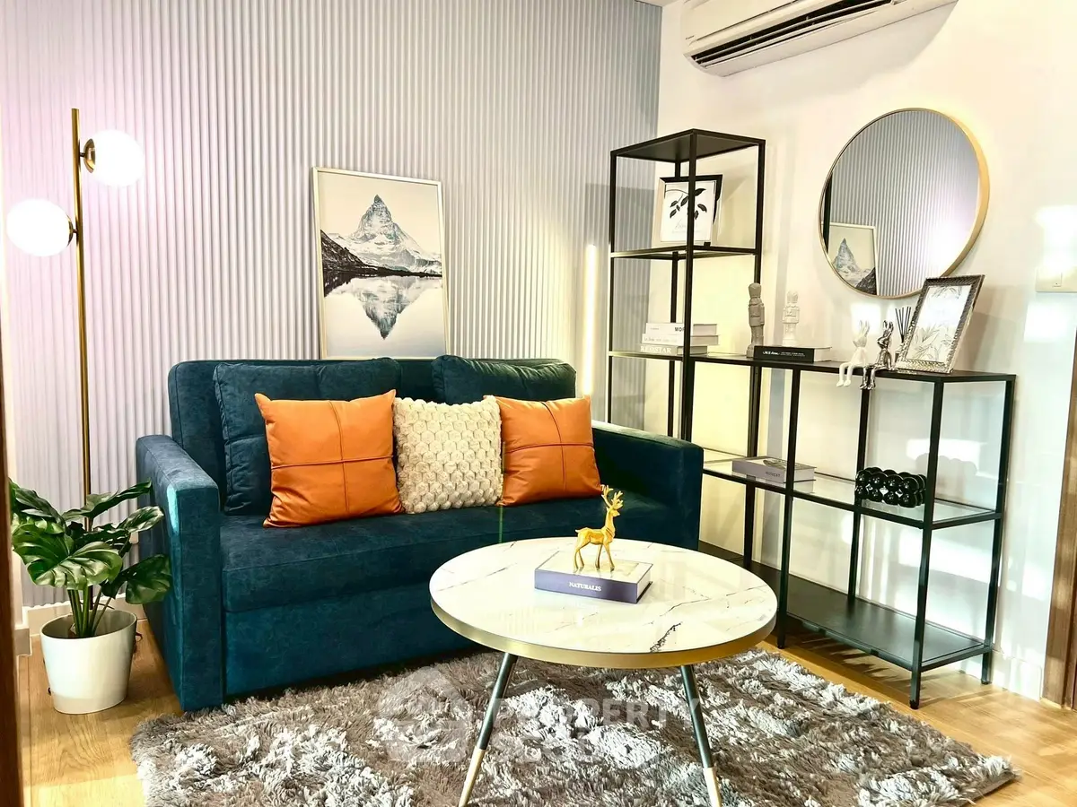 Stylish living room with modern decor, featuring a plush sofa, elegant shelving, and chic lighting.
