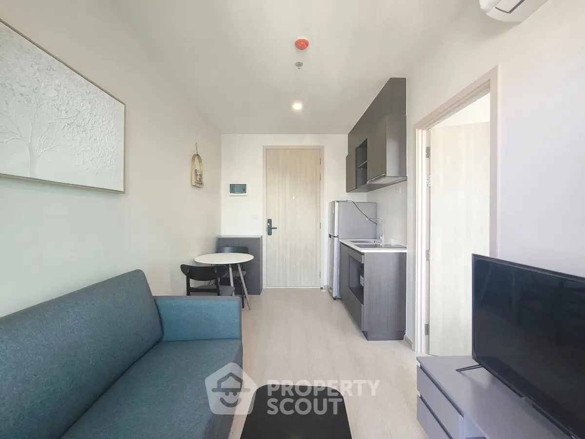 Modern apartment living room with compact kitchen and stylish furniture