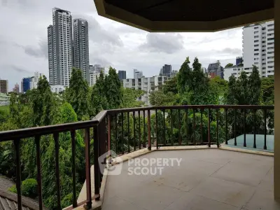 Spacious balcony with stunning cityscape and lush greenery views, perfect for relaxation and entertainment.