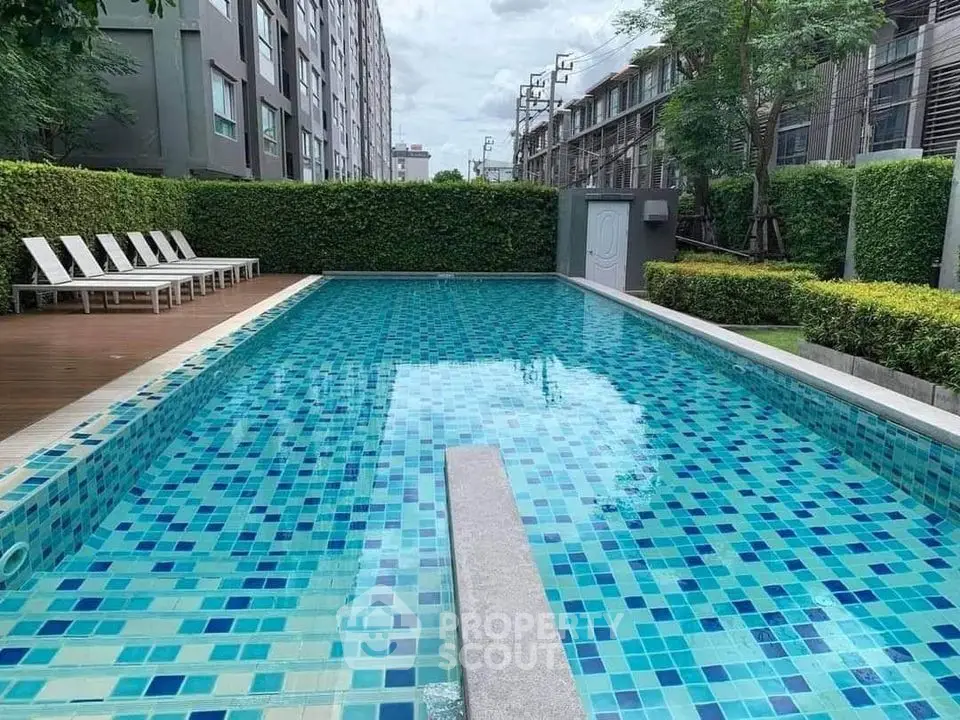 Stunning outdoor swimming pool with modern design in a residential complex.