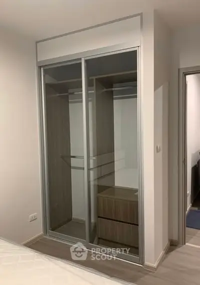 Modern bedroom with sleek sliding wardrobe and minimalist design