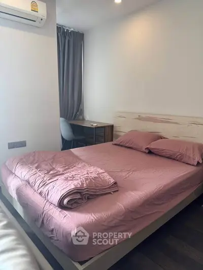 Cozy bedroom with modern furnishings and natural light, perfect for relaxation and comfort.