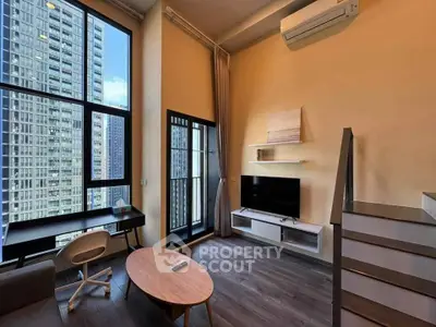 Modern loft apartment with high ceilings, large windows, and sleek furnishings.