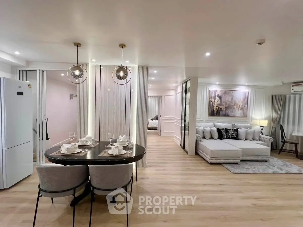 Luxurious open-plan living room with elegant dining area and modern decor