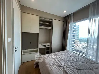 Modern bedroom with built-in wardrobe and city view from large window