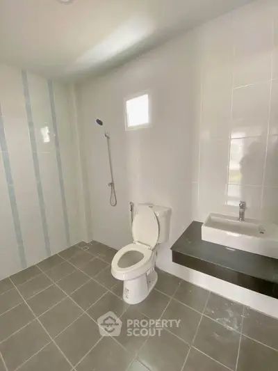 Spacious modern bathroom with sleek fixtures and tiled walls