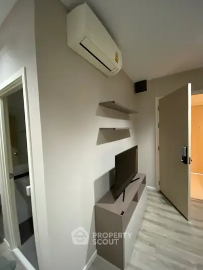 Modern living room with air conditioning and sleek TV setup, perfect for cozy urban living.