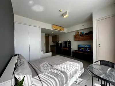 Modern bedroom with stylish decor and natural light, featuring a cozy bed and sleek furniture.