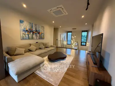 Luxurious living room with modern decor, spacious seating, and elegant lighting