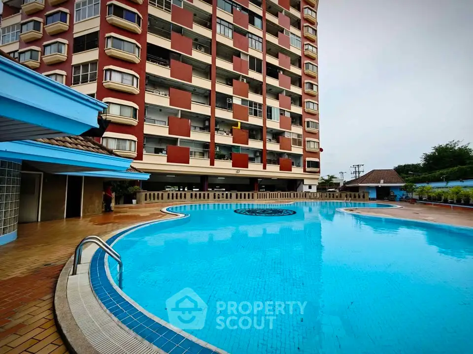 Luxurious apartment building with a stunning outdoor pool and modern amenities.