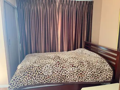 Cozy bedroom with stylish leopard print bedding and elegant curtains
