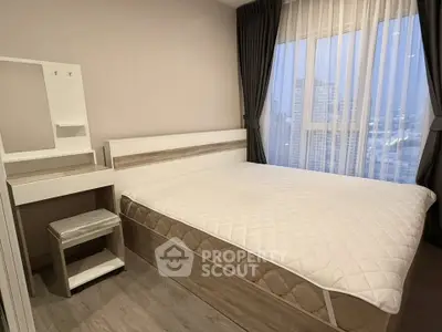 Modern bedroom with large window and city view, featuring a stylish bed and vanity set.