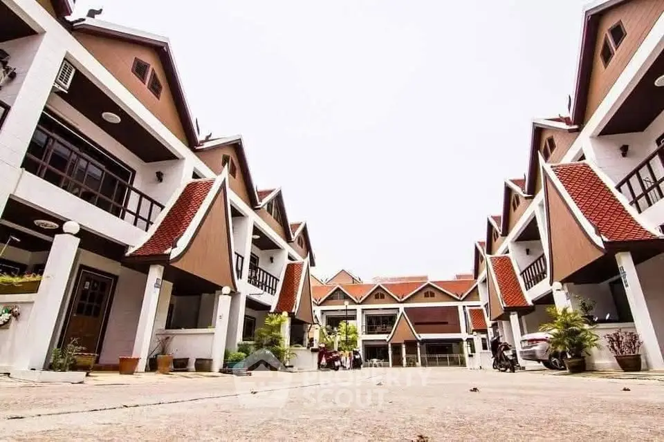 Charming townhouse complex with unique architectural design and spacious outdoor area.