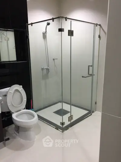 Modern bathroom with glass shower enclosure and sleek fixtures