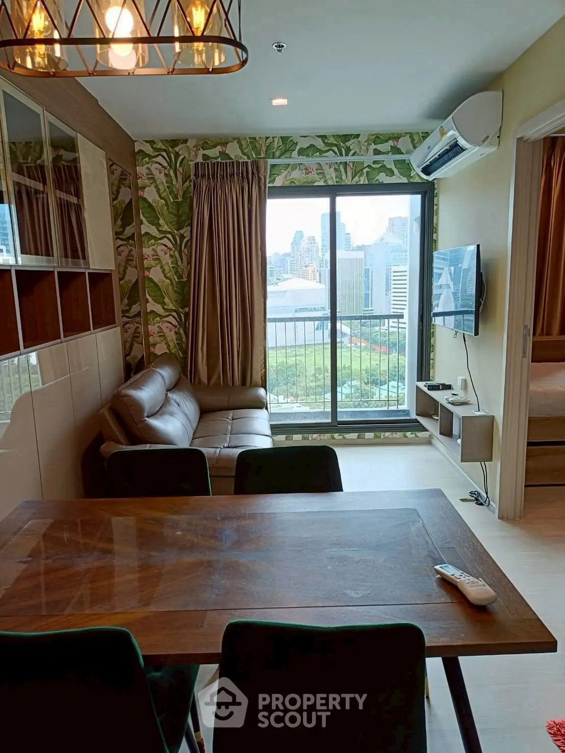 Stylish living room with city view, modern furniture, and elegant decor in a high-rise apartment.