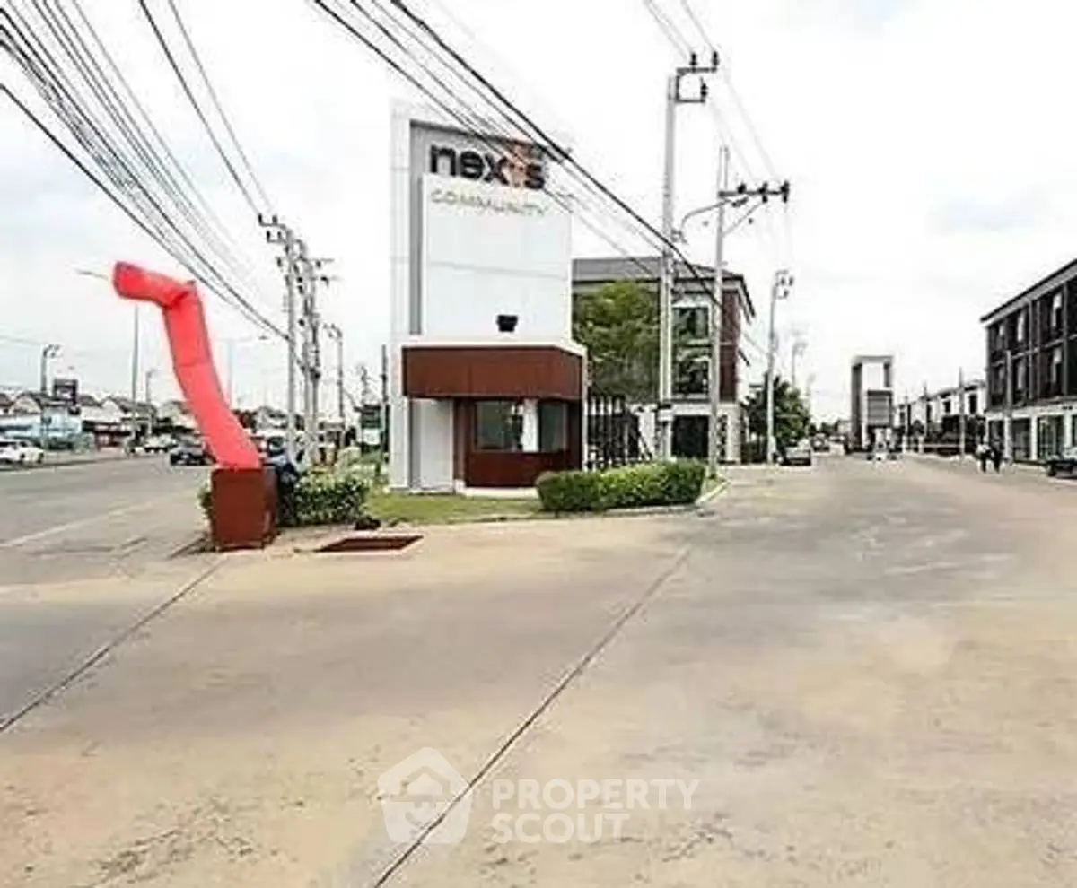 Modern commercial building exterior with ample parking and street view