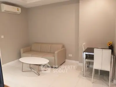 Modern living room with beige sofa and dining area in stylish apartment