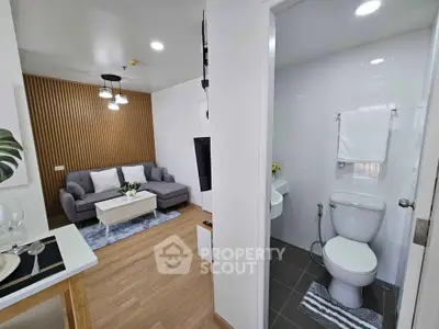 Modern apartment interior with cozy living room and sleek bathroom design.