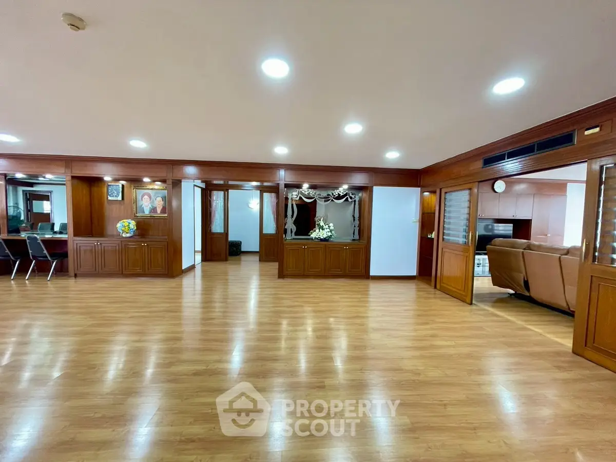 Spacious living room with wooden flooring and elegant decor in a luxurious property.