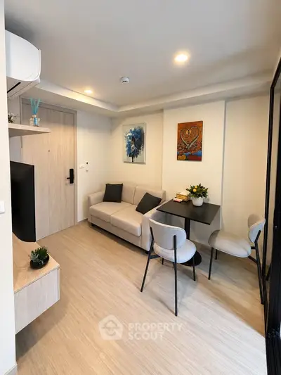 Modern living room with cozy seating and stylish decor in a contemporary apartment.