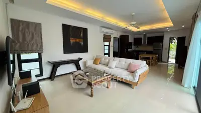 Spacious modern living room with elegant decor and open kitchen layout