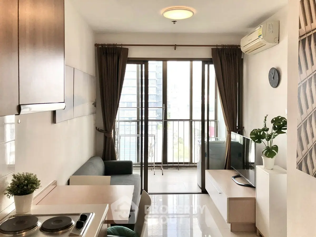 Modern living room with balcony view, stylish decor, and natural light