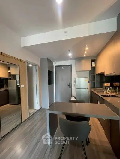 Modern kitchen with sleek design, open layout, and stylish furnishings in a contemporary apartment.