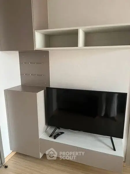 Modern living room with sleek TV setup and stylish storage solutions.