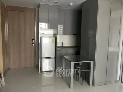 Modern compact kitchen with sleek cabinetry and integrated appliances