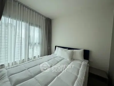 Cozy bedroom with large window and modern decor in a stylish apartment