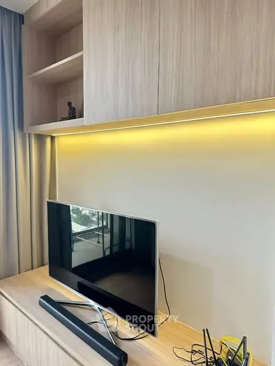 Modern living room with sleek TV setup and ambient lighting