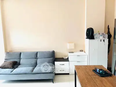 Modern living room with stylish sofa and wooden table, perfect for cozy gatherings.