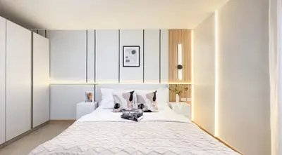Modern bedroom with stylish decor and ambient lighting