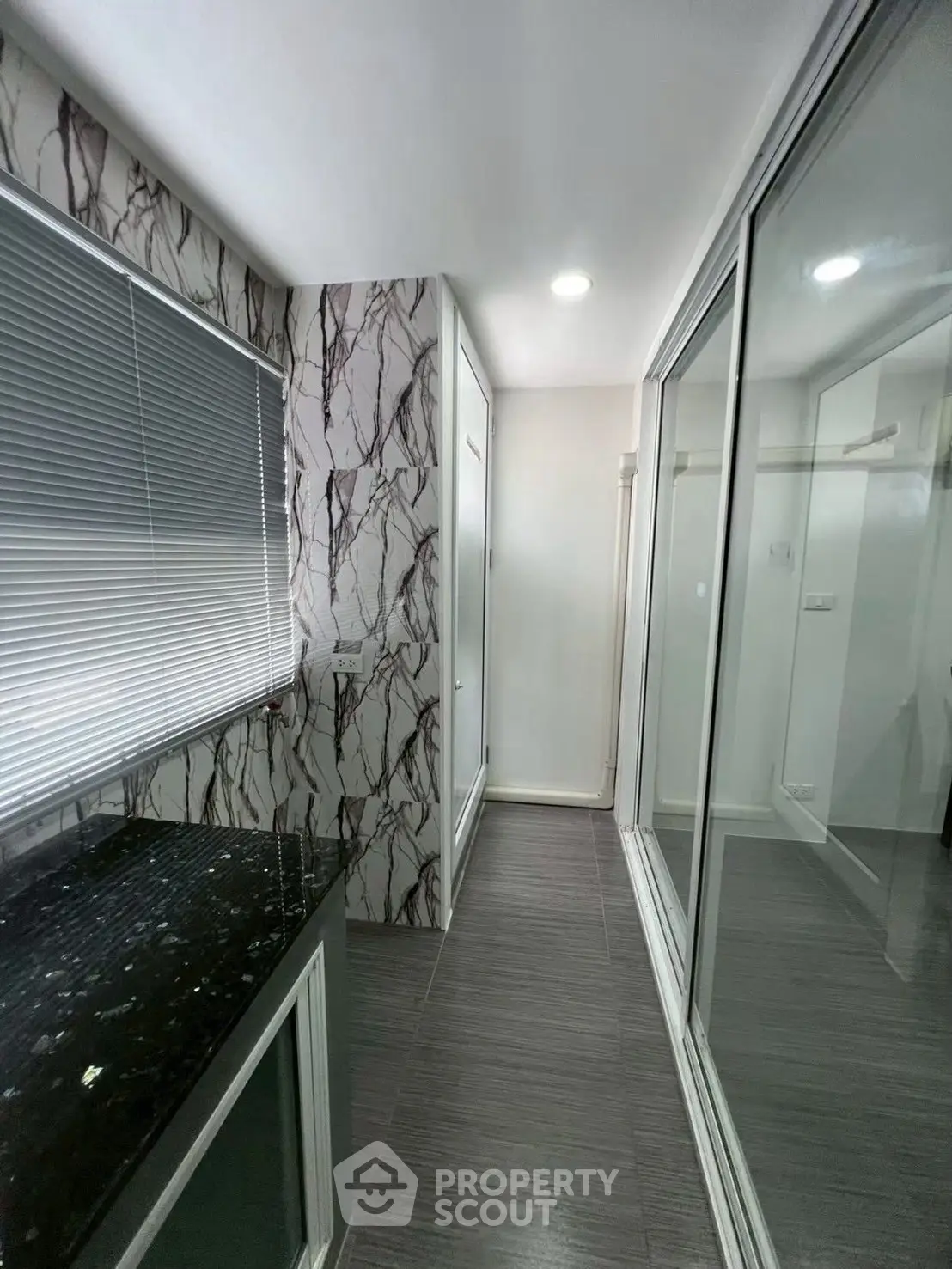 Modern bathroom with marble accents and sleek glass shower enclosure