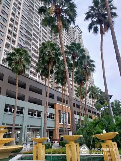 Luxurious high-rise building with palm trees and elegant fountain in urban setting