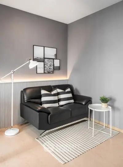 Modern living room with stylish black sofa and minimalist decor