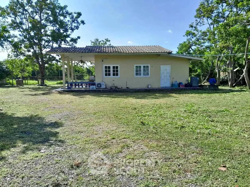 Charming countryside house with spacious yard and lush greenery, perfect for serene living.