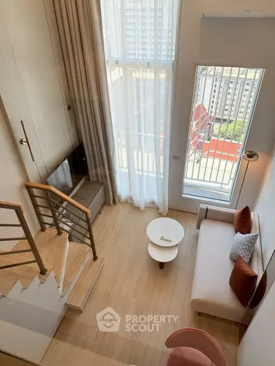 Modern duplex living room with high ceilings and large windows