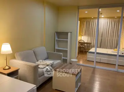 Cozy living room with modern furniture and warm lighting in a stylish apartment.