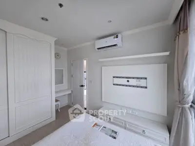 Cozy bedroom with air conditioning and elegant white decor, perfect for relaxation.