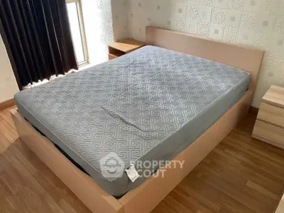Spacious bedroom with modern wooden bed frame and stylish decor
