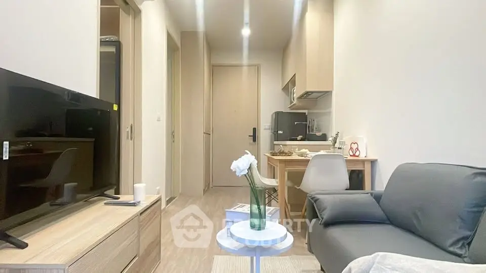 Modern living room with sleek furniture and open kitchen layout, perfect for urban living.