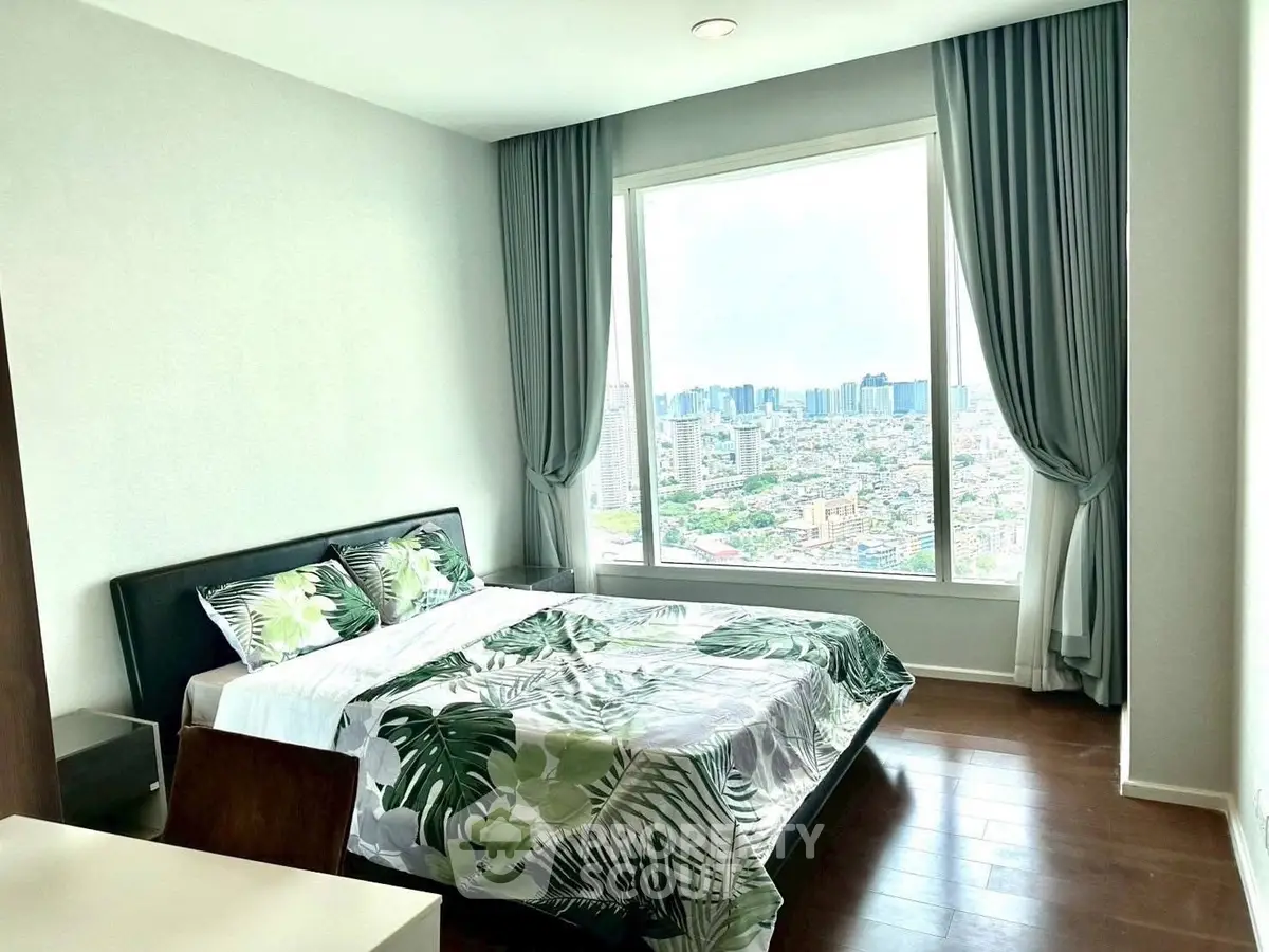 Bright bedroom with large window offering stunning city view, featuring modern decor and wooden flooring.