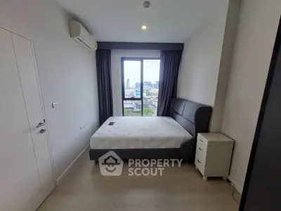 Modern bedroom with city view, featuring a comfortable bed and sleek design in a high-rise apartment.