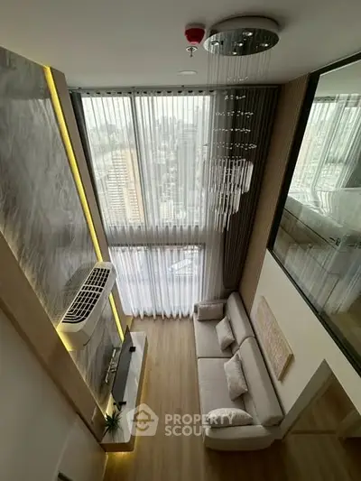 Luxurious high-ceiling living room with panoramic city views and elegant decor.