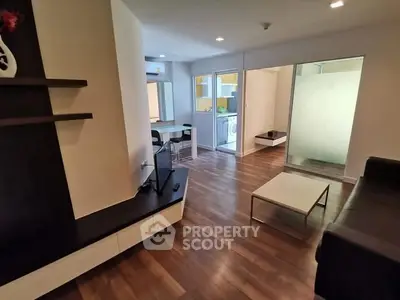 Modern living room with sleek wooden flooring and open layout design