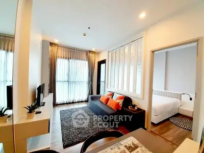 Modern living room with cozy decor and natural light, adjacent to a stylish bedroom.